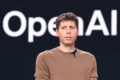 Sam Altman no palco da conferência da OpenAI com logotipo da empresa e gráfico de IPO parado