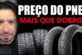 Pneus de motocicleta empilhados em armazém industrial com gráfico de importações crescentes