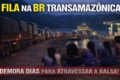 Fila de caminhões aguardando balsa para cruzar Rio Guaporé após interdição da ponte BR-174B em MT