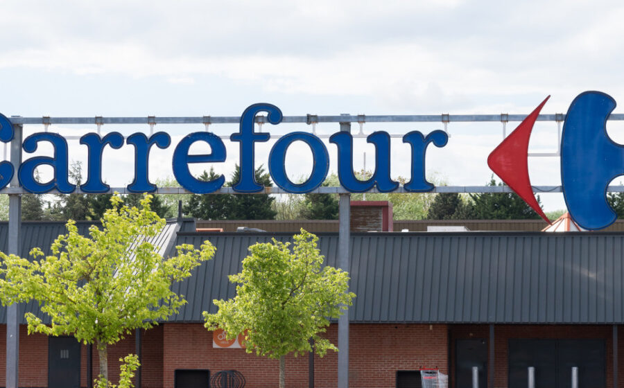 Fachada de supermercado Carrefour Bairro com logotipo, representando venda de 21 lojas ao Grupo Pereira