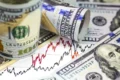 Gráfico mostra dólar recuando para R$ 5,39 após alta histórica de 8,21% e Ibovespa caindo 13,88%