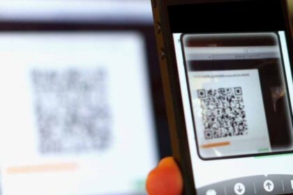 Pessoa escaneando QR Code adulterado com smartphone em restaurante, golpe do Pix