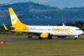 Avião da Flybondi no aeroporto com texto sobre saída do Brasil e apenas três low costs restantes