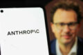 Dario Amodei, CEO da Anthropic, em retrato profissional com fundo de código neural representando IA segura