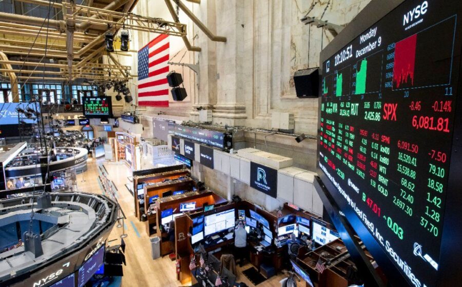 GPUs empilhadas como barris de petróleo em piso de bolsa de valores com telas de cotação
