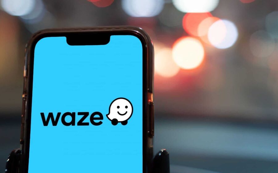 Uri Levine, cofundador do Waze, sorri em evento no Brasil com fundo dourado simbolizando oportunidade